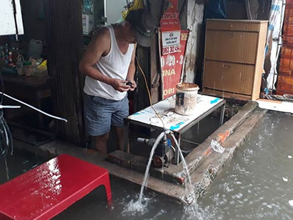 Ảnh: Mưa lớn, người HN dùng máy bơm "giải cứu" nhà khỏi nước ngập