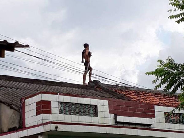 Nam thanh niên trèo lên nóc nhà dân ngồi hát nghêu ngao